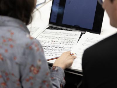 participant sitting at desk looking at manuscript paper